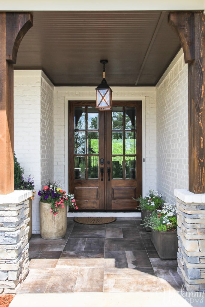 Pretty front porch with rustic wood and stone columns